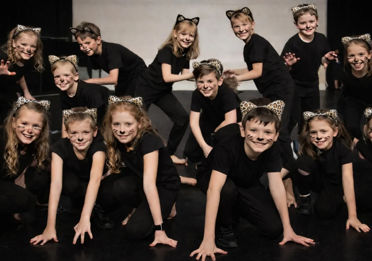 Young performers in cat costumes during Cats musical production
