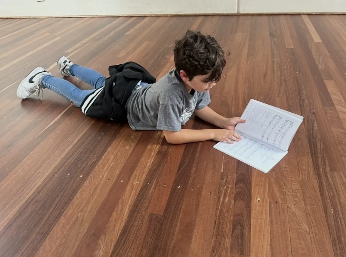 Students using a prop during an improvisation activity at a speech and drama class