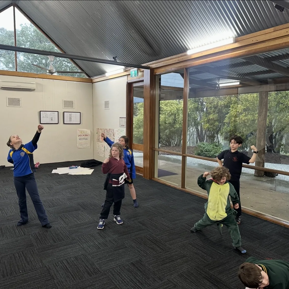 Speech and drama students stretching and moving during a warm-up class