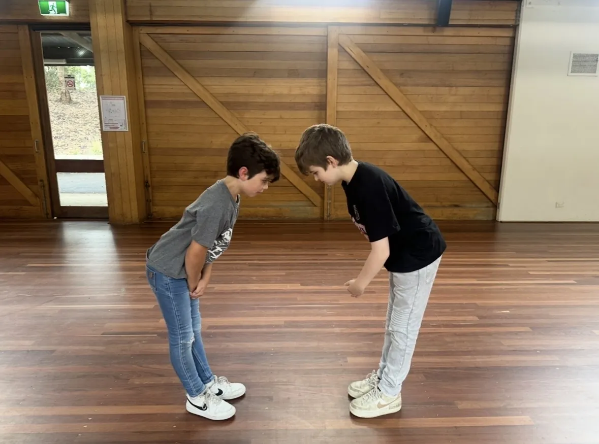 Two students taking a bow during rehearsal at Ranges Studio