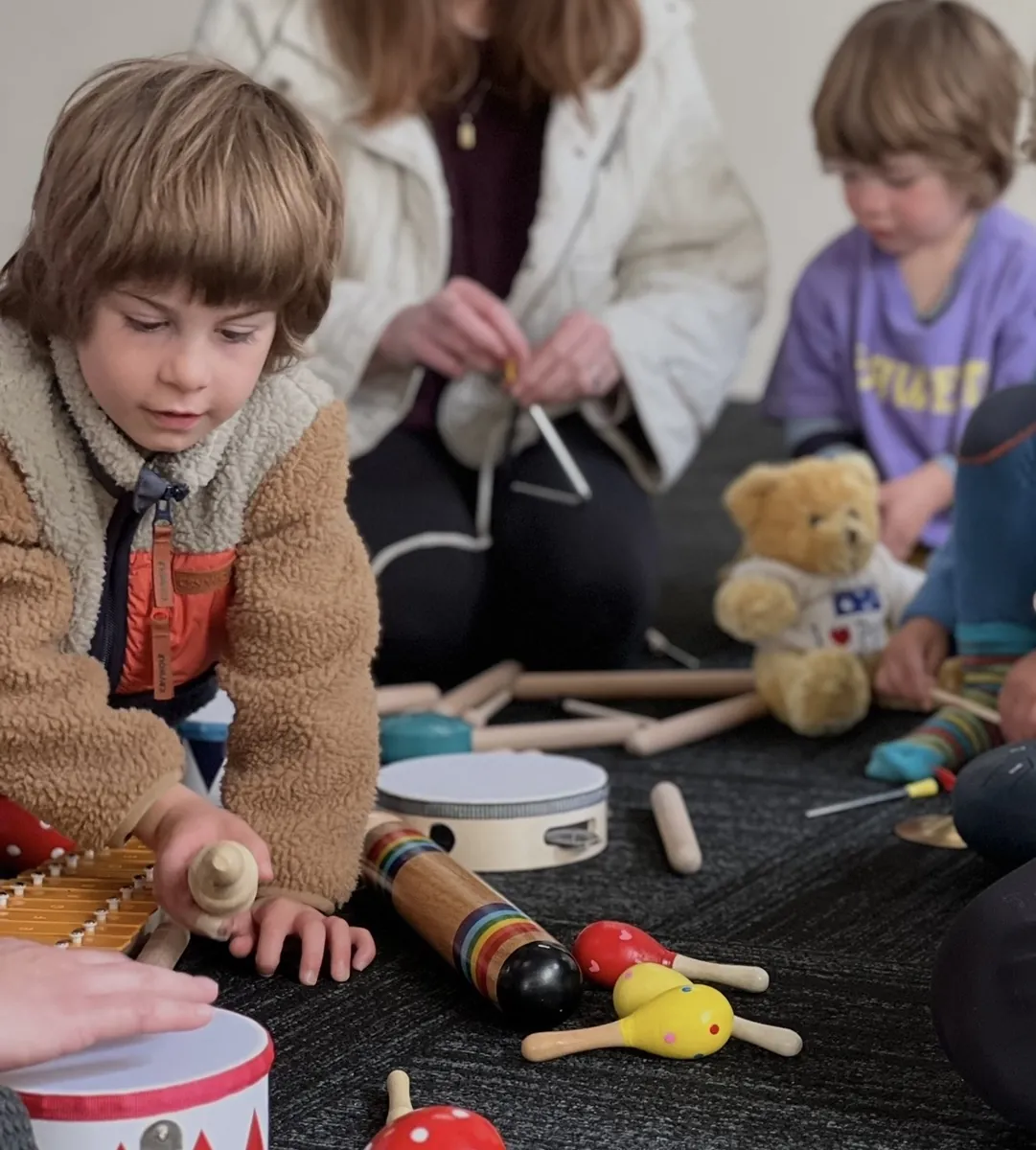 Toddler in dress-up costume during imaginative play at a Tell & Show class
