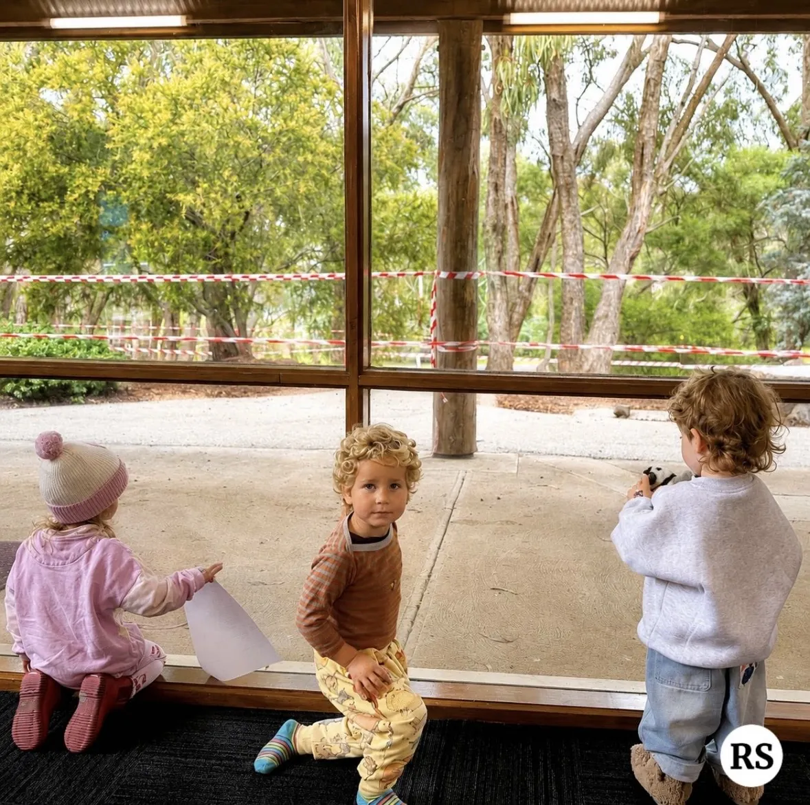 Young children exploring together by the window during a Tell & Show session
