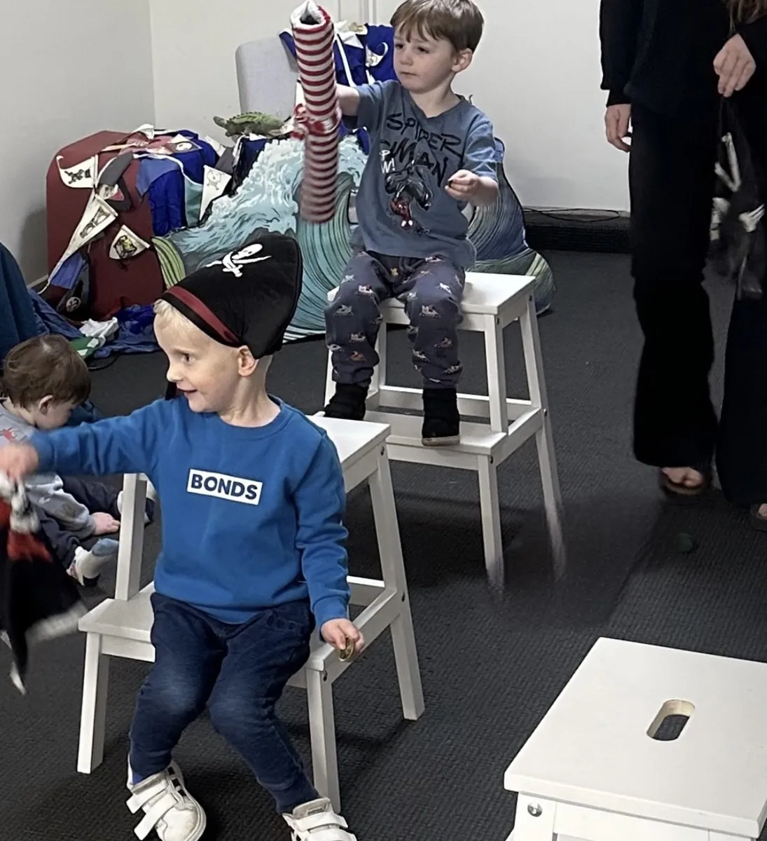 Group of young children gathered at the activity stools at a Tell & Show class