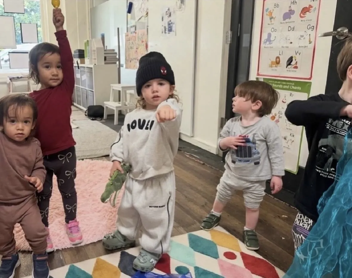 Young children sharing a storybook during a Tell & Show class