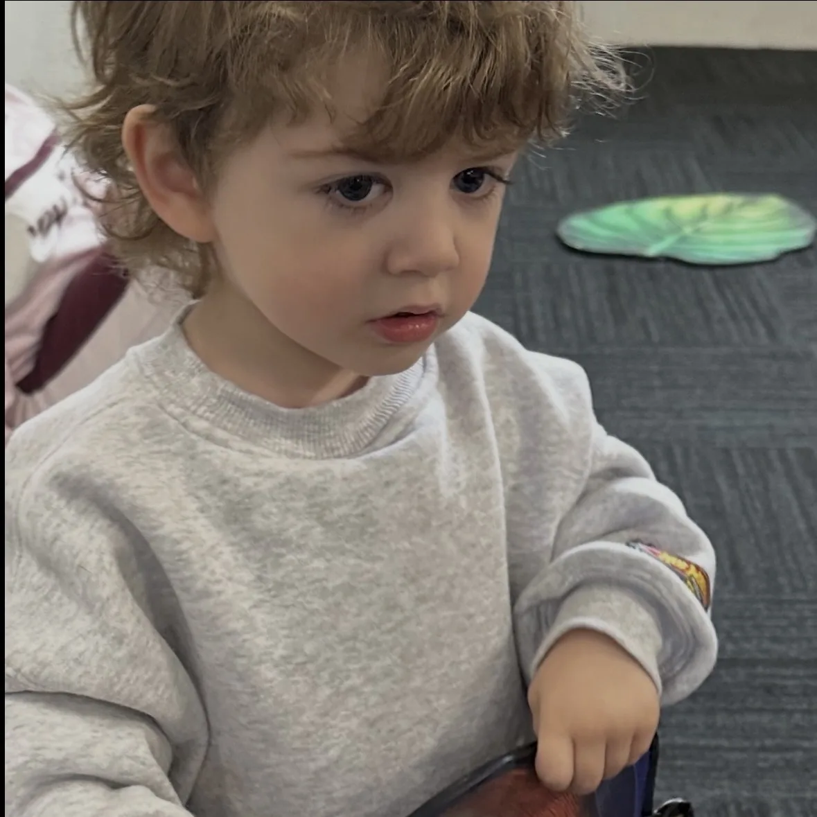 Thoughtful toddler during a Tell & Show early learners class at Ranges Studio